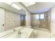 Bathroom featuring tiled shower/tub combo and seashell themed wall paper at 1115 Venture Ct, Punta Gorda, FL 33983