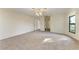 Open bedroom area featuring neutral paint, carpet, a ceiling fan and large picture window at 1115 Venture Ct, Punta Gorda, FL 33983