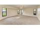 Bright and spacious bedroom featuring neutral carpeting, a ceiling fan and several windows for natural light at 1115 Venture Ct, Punta Gorda, FL 33983