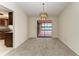Formal dining area with sliding glass doors leading to an outdoor space, adjacent to a kitchen at 1115 Venture Ct, Punta Gorda, FL 33983