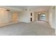 Open living area with neutral carpet, recessed lighting and sliding glass door to screened porch at 1115 Venture Ct, Punta Gorda, FL 33983