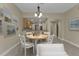 Dining area near the kitchen featuring a stylish table and chairs with a modern pendant light fixture at 240 W End Dr # 412, Punta Gorda, FL 33950