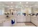 Bright bathroom with a tub, white cabinets, tiled flooring, and a large mirror, creating a spa-like atmosphere at 5430 Almar Dr, Punta Gorda, FL 33950