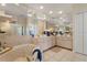 Bright bathroom featuring a soaking tub, double vanity, tiled flooring, and a large mirror, creating a spa-like atmosphere at 5430 Almar Dr, Punta Gorda, FL 33950