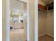Hallway view of a bright bathroom featuring a soaking tub, double vanity, tiled flooring, and a large mirror at 5430 Almar Dr, Punta Gorda, FL 33950