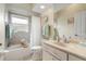 Bathroom with a shower, vanity, mirror, and neutral color scheme, creating a clean and inviting space at 5430 Almar Dr, Punta Gorda, FL 33950