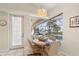 Bright breakfast nook overlooking the screened-in patio, swimming pool and water at 5430 Almar Dr, Punta Gorda, FL 33950