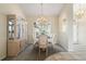 Elegant dining room with chandelier, wainscotting and stylish china cabinet near a large arched window at 5430 Almar Dr, Punta Gorda, FL 33950