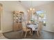 Cozy dining room featuring a classic china cabinet, elegant chandelier, and large window at 5430 Almar Dr, Punta Gorda, FL 33950