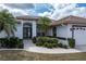 Attractive home with dark-trimmed windows, double-door entrance, and well-maintained landscaping at 5430 Almar Dr, Punta Gorda, FL 33950