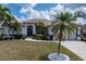 Charming one-story home featuring manicured landscaping, a concrete driveway, and a tiled roof at 5430 Almar Dr, Punta Gorda, FL 33950