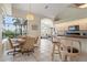 Bright eat-in kitchen with a counter bar, tile floors and a large window overlooking a screened-in patio at 5430 Almar Dr, Punta Gorda, FL 33950