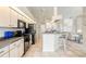 Spacious kitchen with tile floors, appliances, a counter bar, and views to the living room at 5430 Almar Dr, Punta Gorda, FL 33950