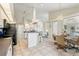 Bright kitchen featuring tile flooring, white cabinets and a counter bar with seating at 5430 Almar Dr, Punta Gorda, FL 33950