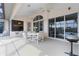 Spacious lanai featuring multiple ceiling fans, a dining table, and picturesque views of the pool and waterway at 5430 Almar Dr, Punta Gorda, FL 33950