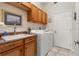 Efficient laundry room with overhead cabinets, a sink with ample counter space, and included washer/dryer at 5430 Almar Dr, Punta Gorda, FL 33950