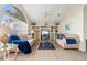Comfortable living room featuring built-in shelving, large windows, and neutral decor at 5430 Almar Dr, Punta Gorda, FL 33950