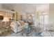 Bright living room featuring high ceilings, tile floors, comfortable seating, and a seamless flow to the dining area at 5430 Almar Dr, Punta Gorda, FL 33950