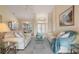 Spacious living room featuring comfortable seating, a view of the dining area, and elegant decor at 5430 Almar Dr, Punta Gorda, FL 33950