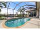 Relaxing screened-in pool area with waterfront views and lounge chairs at 5430 Almar Dr, Punta Gorda, FL 33950