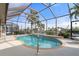 Inviting screened-in pool area with a charming in-ground pool, perfect for relaxation and enjoying the waterfront view at 5430 Almar Dr, Punta Gorda, FL 33950