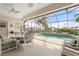 Relaxing screened-in lanai with a sparkling pool, a dining table, and scenic waterfront vistas at 5430 Almar Dr, Punta Gorda, FL 33950