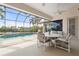 Inviting screened-in lanai with a sparkling pool, comfortable seating, and serene water views at 5430 Almar Dr, Punta Gorda, FL 33950