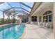 Inviting screened-in pool area with seating and lovely views, perfect for relaxation and outdoor enjoyment at 5430 Almar Dr, Punta Gorda, FL 33950