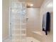 Tiled shower with glass block wall, shower head, and convenient seating adding to an elegant bathroom at 5430 Almar Dr, Punta Gorda, FL 33950