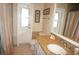 Bathroom with shower, sink with stone counter, and view to the backyard at 721 Brenda Ct, Punta Gorda, FL 33950