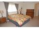 Cozy bedroom featuring a comfortable bed and a classic wood dresser set at 721 Brenda Ct, Punta Gorda, FL 33950