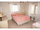 Bright bedroom with tiled floor, two side tables, and large windows at 721 Brenda Ct, Punta Gorda, FL 33950