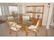 Charming dining area with a glass-top table and unique bamboo chairs at 721 Brenda Ct, Punta Gorda, FL 33950