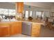 Kitchen bar with breakfast seating, featuring a tile countertop and stainless steel dishwasher at 721 Brenda Ct, Punta Gorda, FL 33950