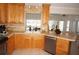 Bright kitchen featuring light wood cabinetry, tile countertops, and stainless steel appliances at 721 Brenda Ct, Punta Gorda, FL 33950