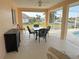 The lanai features an outdoor dining set, ceiling fan, and view of the water at 721 Brenda Ct, Punta Gorda, FL 33950