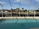 The screened-in pool has a view of the canal at 721 Brenda Ct, Punta Gorda, FL 33950