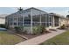 Exterior view of the screened-in pool and backyard at 721 Brenda Ct, Punta Gorda, FL 33950