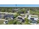 Aerial view showcasing a home with a screened pool enclosure and solar panels on the roof at 18395 Edgewater Dr, Port Charlotte, FL 33948