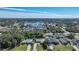 Panoramic aerial view featuring waterfront homes nestled among lush greenery, with ocean horizon at 18395 Edgewater Dr, Port Charlotte, FL 33948