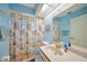 Well lit bathroom featuring blue walls, novelty shower curtain, and tile floors at 18395 Edgewater Dr, Port Charlotte, FL 33948