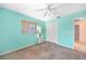 Cozy bedroom featuring carpeted floors, a ceiling fan, and a window for natural light at 18395 Edgewater Dr, Port Charlotte, FL 33948