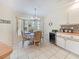 Cozy dining area features a charming table set for four, bay window, and beach decor at 18395 Edgewater Dr, Port Charlotte, FL 33948