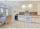 Charming dining area features a table set for four, cabinets, and view of the backyard at 18395 Edgewater Dr, Port Charlotte, FL 33948