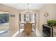Bright dining area features a table set for four, chandelier, and view of the enclosed patio at 18395 Edgewater Dr, Port Charlotte, FL 33948