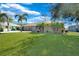 Charming home with a well-manicured lawn and beautiful landscaping, creating a welcoming curb appeal at 18395 Edgewater Dr, Port Charlotte, FL 33948