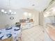 Bright eat-in kitchen featuring white appliances, tile backsplash, and tile floors at 18395 Edgewater Dr, Port Charlotte, FL 33948