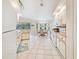 Spacious kitchen and dining area featuring tile flooring, lots of cabinets, and views of the outdoors at 18395 Edgewater Dr, Port Charlotte, FL 33948