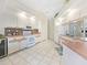 Bright eat-in kitchen featuring white appliances, tile backsplash, and tile floors at 18395 Edgewater Dr, Port Charlotte, FL 33948