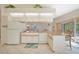 Bright kitchen features ample counter space, white appliances and cabinets, as well as a breakfast bar at 18395 Edgewater Dr, Port Charlotte, FL 33948
